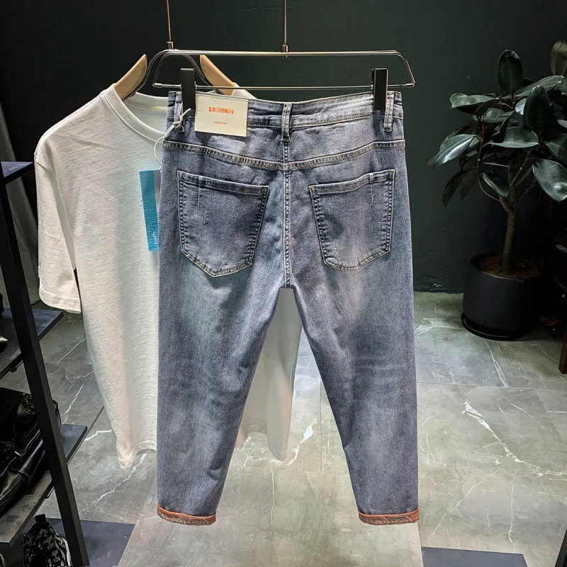 

Spring and summer 2021 new style teenagers ripped denim jeans men's harem pants Korean fashion personality stretch slim trousers