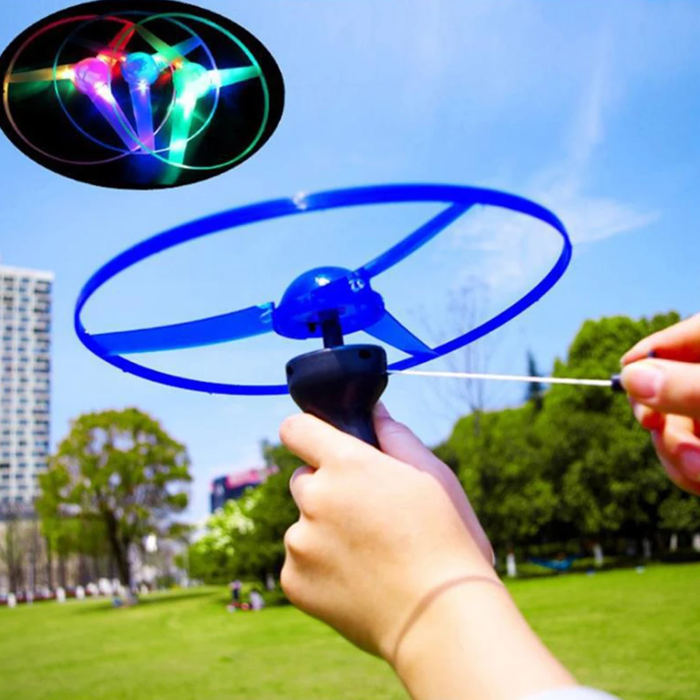 

5pcs Flying Saucer Helicopter Pull String UFO Spin LED Light Flying Disc Toys Outdoor Toys (Random Color)