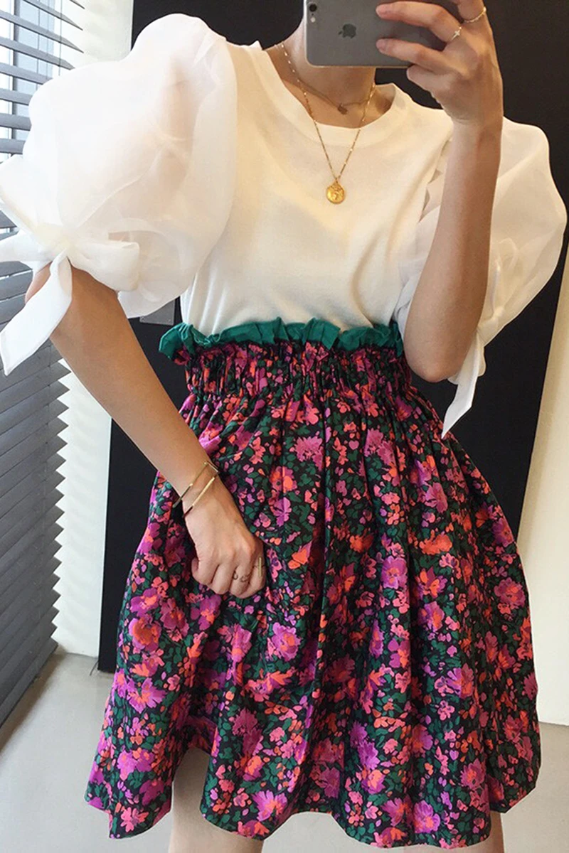 

Korean version of 2021 spring and summer temperament loose tie bow puff sleeve sweater + pleated high waist flower A-line skirt