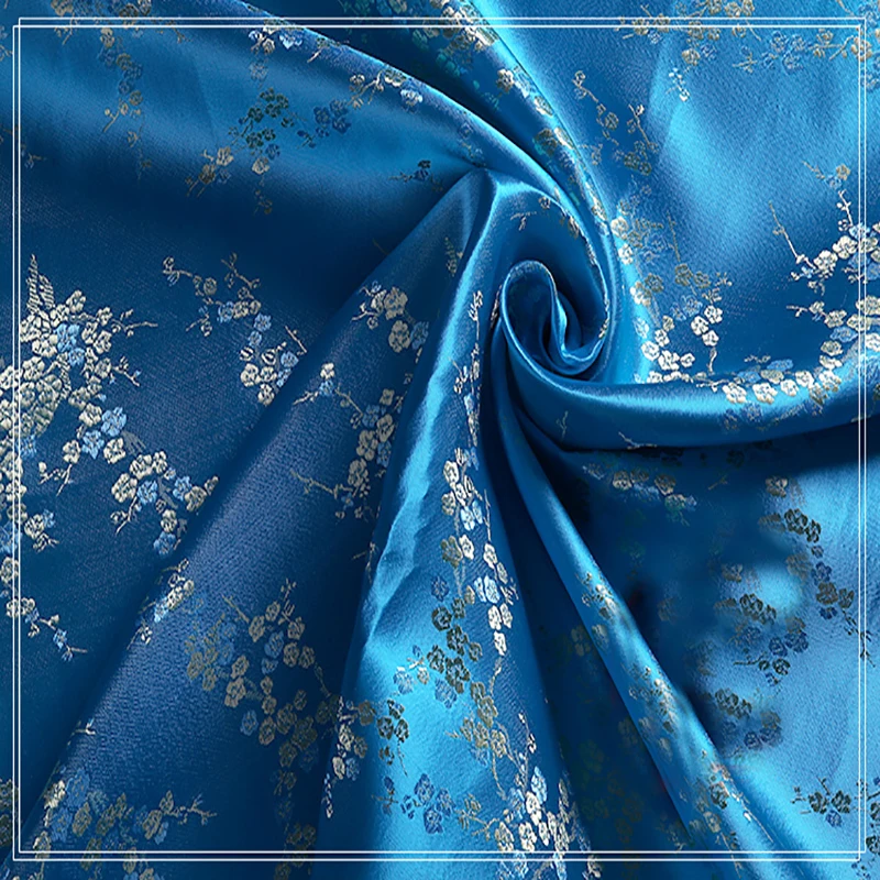 Tela de alta calidad de brocado jacquard para mujer, tejido de poliéster azul y dorado con flor de ciruela para retazos, vestido, edredón de fieltro, 100x90