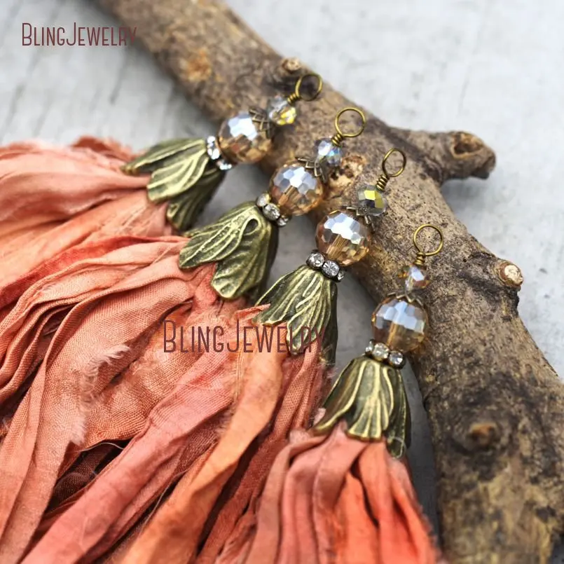 

Coral Peach Orange Sari Silk Tassel Pendant with Antique Bronze Cap and Orange Crystal Accent PM9051