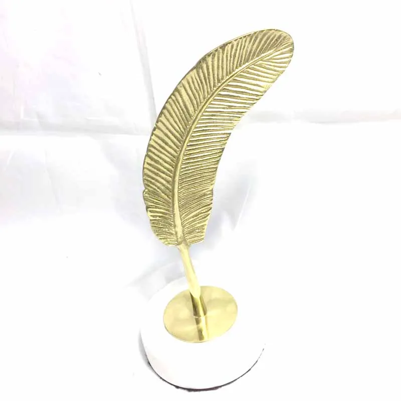 

Beautiful modern creative brass feather home decoration with white marble base