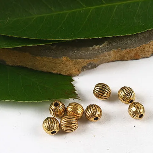 

100pcs dark gold-tone lined spacer beads h2352