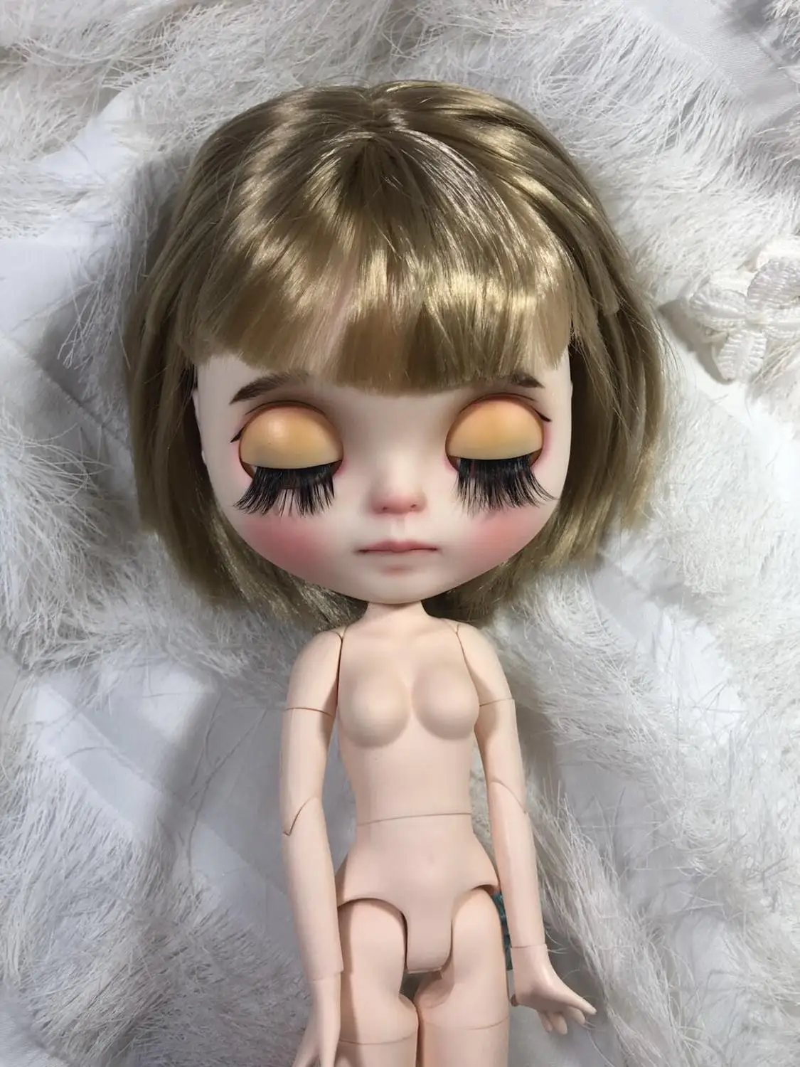 

Cute doll with short blond hair Excluding clothes.