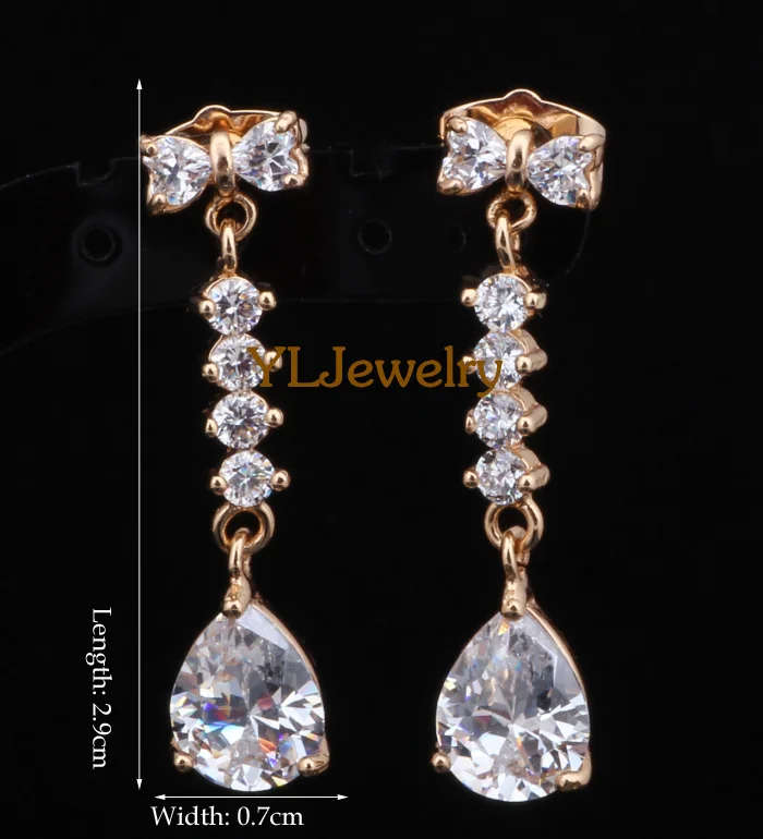 Серьги золотого оттенка в форме капли воды с белыми кристаллами брендовые модные