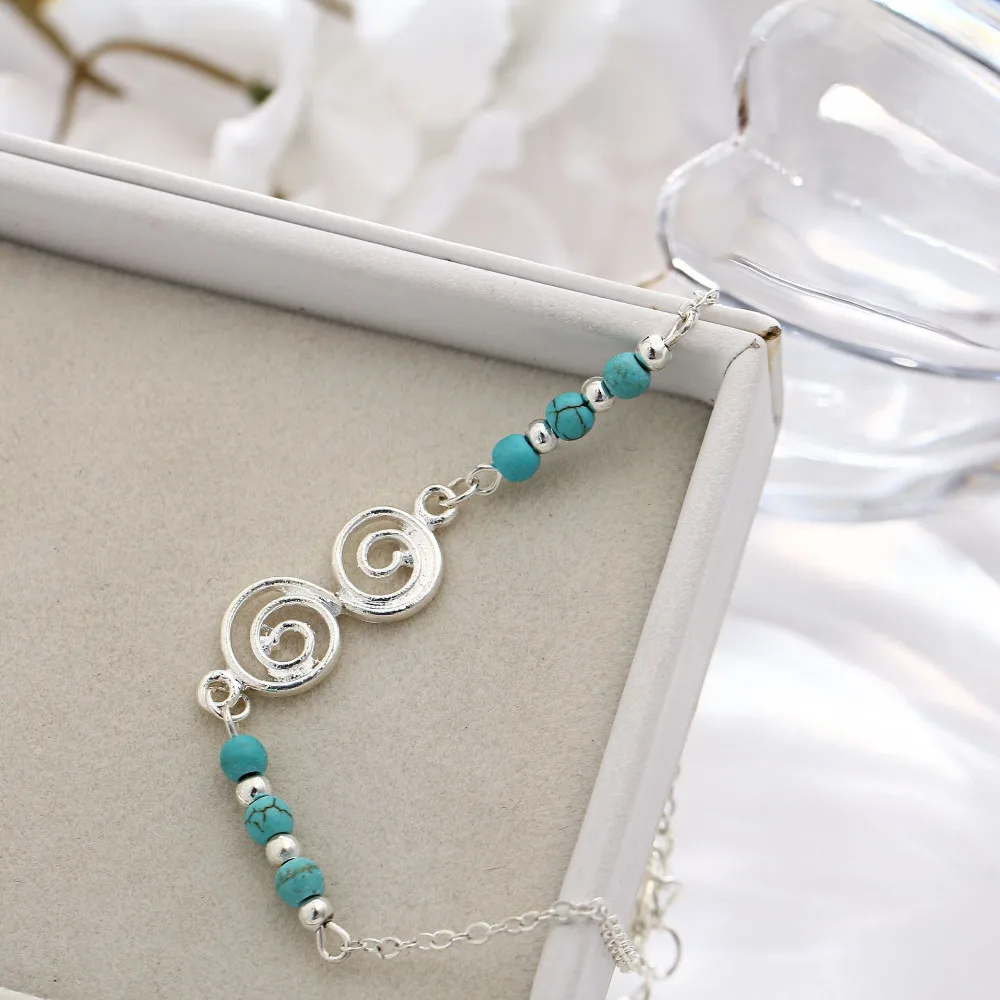 Женские сандалии серебристого цвета с 8 ремешками на лодыжках украшенные синими