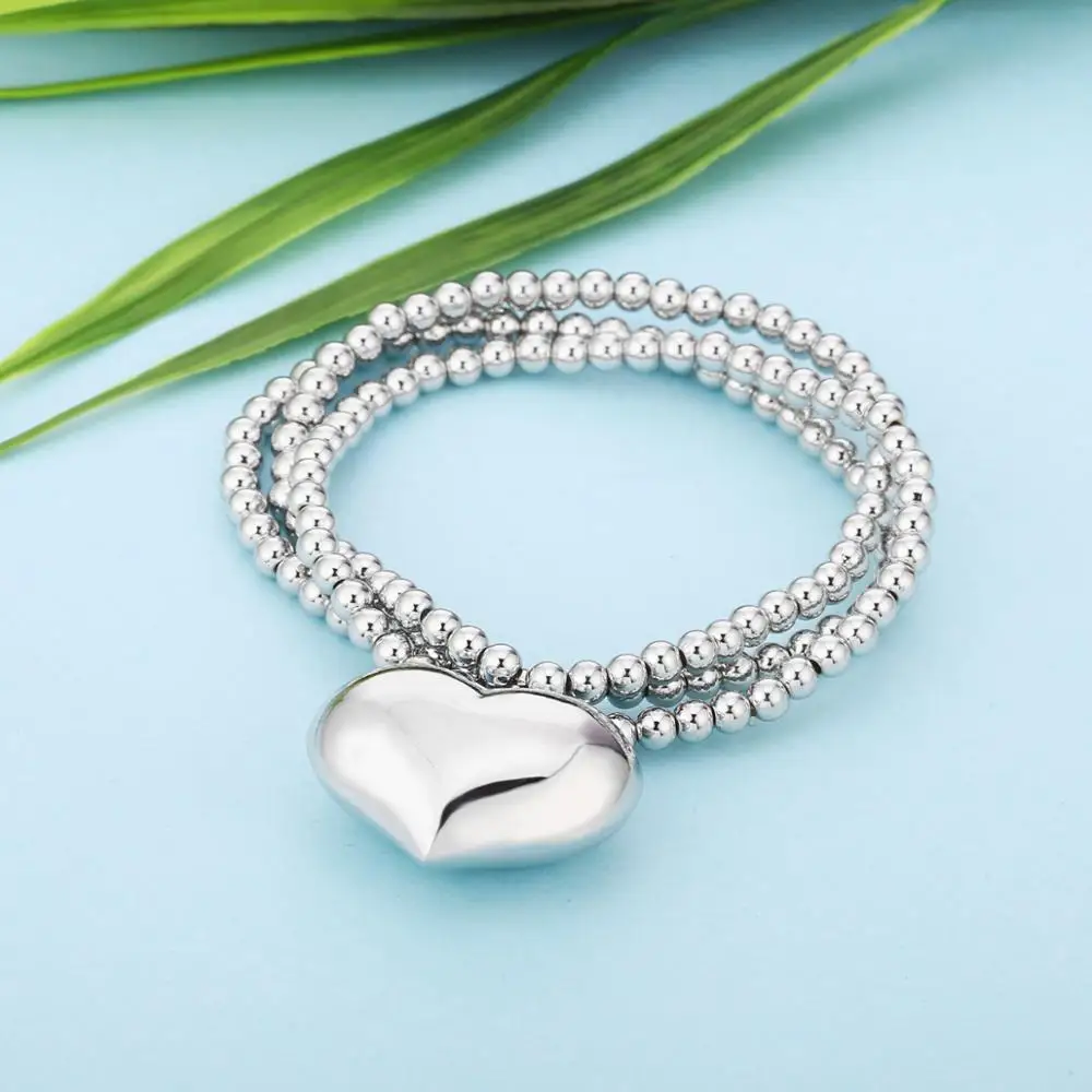 Женский браслет с большим сердечком и колокольчиком эластичный на цепочке