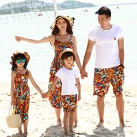 mom daughter bohemian floral sling dress and shawl set dad son white t shirt and floral wide leg shorts set family beach outfits