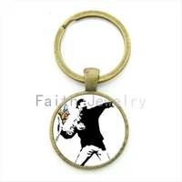banksy protester flowers bouquet graffiti key chain unique interesting design alloy keychain jewelry your finish choice kc210