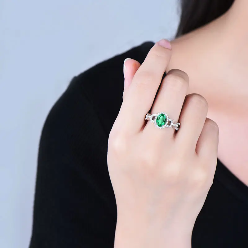 Женское кольцо с овальным камнем 5 х7 мм из твердого белого золота 14 карат зеленым