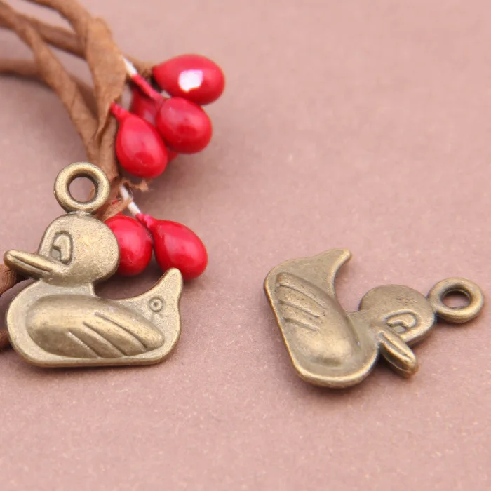 

RAINXTAR New Animal Charms Alloy Cute Duck Pendant Charms 16*18mm 100pcs AAC1488