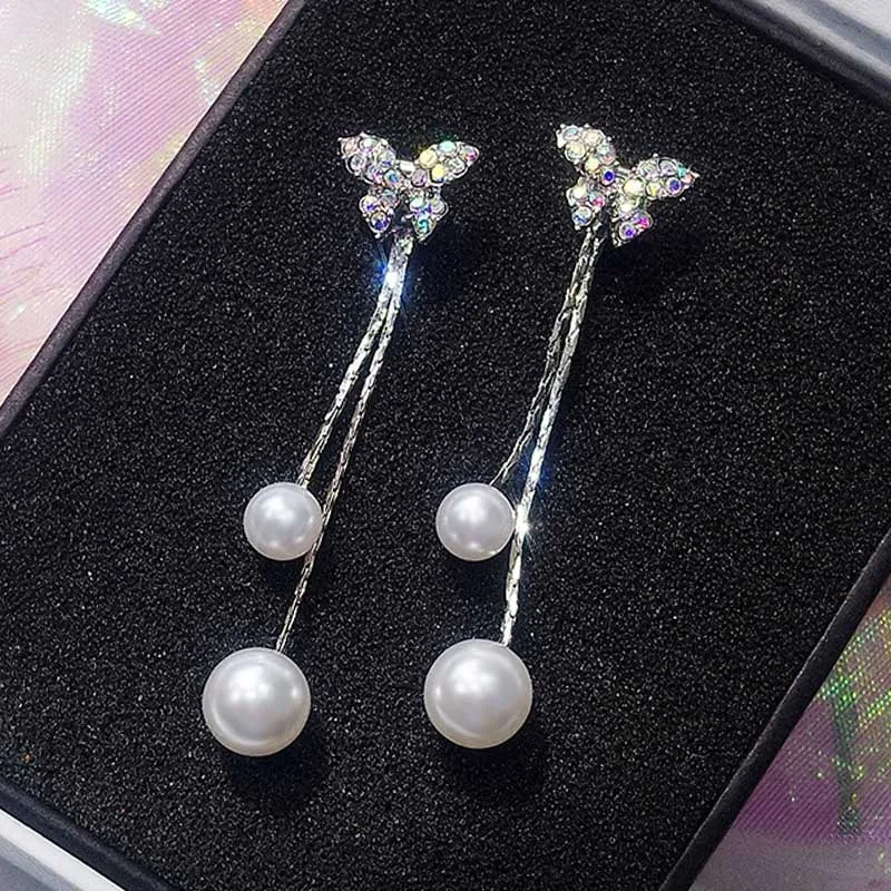 

Bow knot ear nail feminine temperament long Pearl pendant ear pendant personality catapult ear nail jewelry