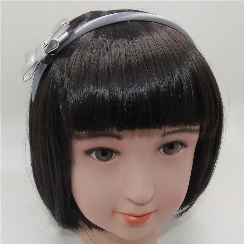 Повязка на голову из искусственной кожи с бантом золотистая/серебристая |