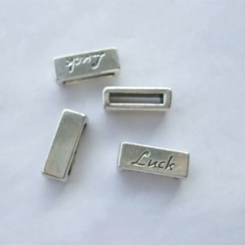 

Wholesale 50pcs Antique Silver Color 10mm Flat Bar Slider Spacer Carved LUCK Beads For 10x2mm Leather Cord Jewelry Findings