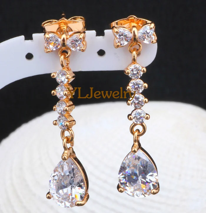 Серьги золотого оттенка в форме капли воды с белыми кристаллами брендовые модные