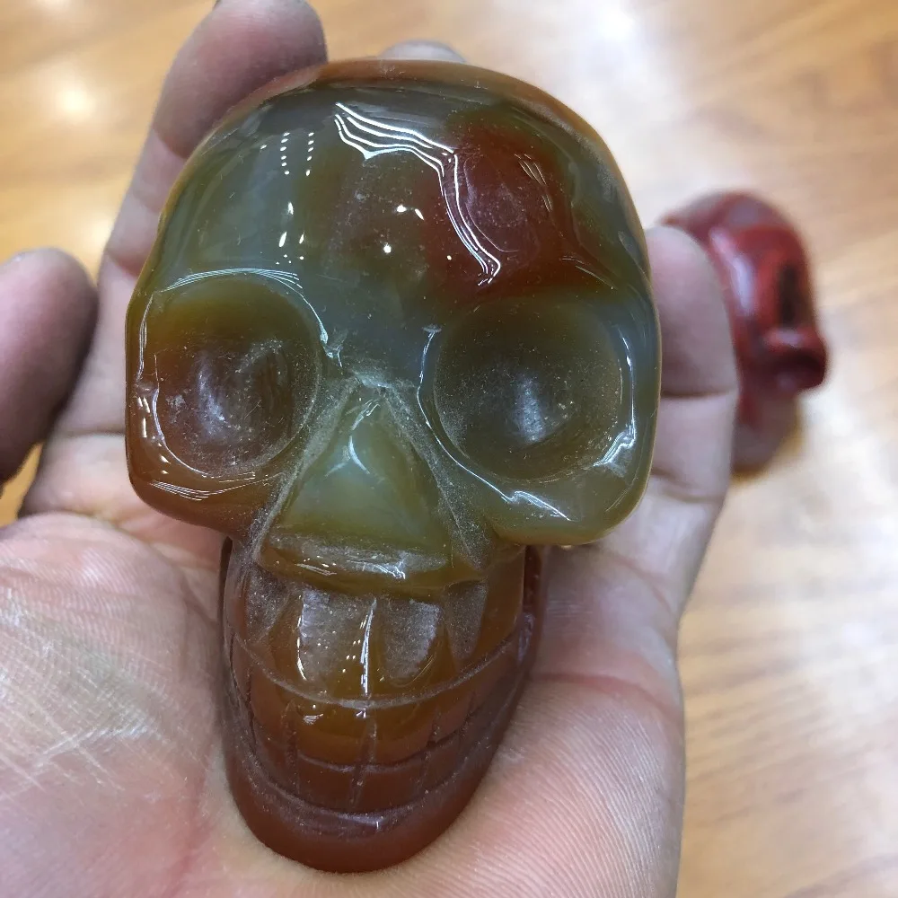 

1pcs Natural Crystal SKULL decoration Stones and Minerals Red agate through the carved by hand