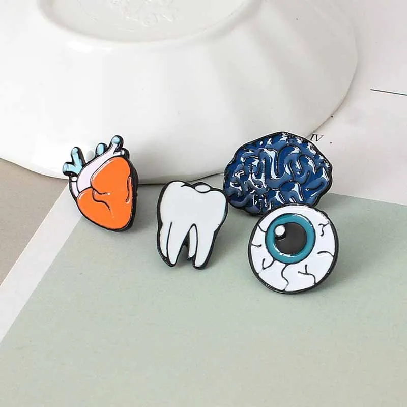 

Korean Version Of Enamel Color Drop Human Brooch Brain Eye Teeth Heart Brooch Accessories Wholesale Pin Badge