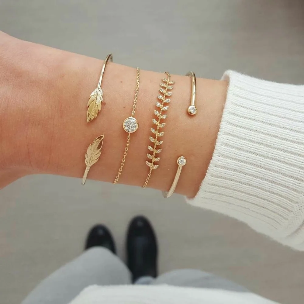 

pack of 4 bangle bracelet with embossed leaves and rhinestone design in burnished in gold tone