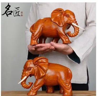 

A pair elephants were carved out yellow flowers pear wood home decoration statue factory direct selling