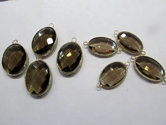 Овальный яйцообразный подвеска из стекла Топаз и Дымчатого кристалла, 12 штук, соединенных фасетированным двойным коннектором, в оригинальной версии из Смоки Рока с покрытием родием.