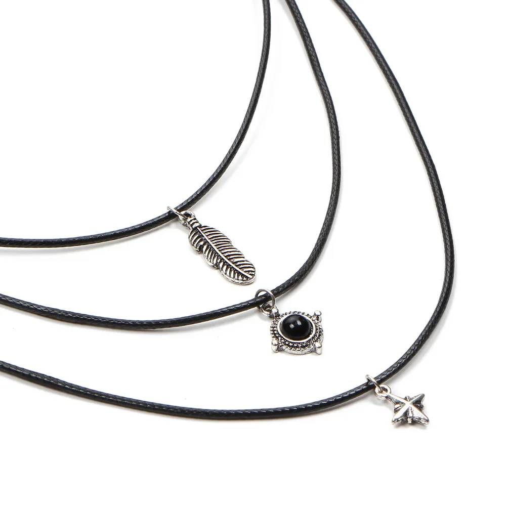 Бархатные ожерелья с перьями листьями звездами кулонами из черного камня