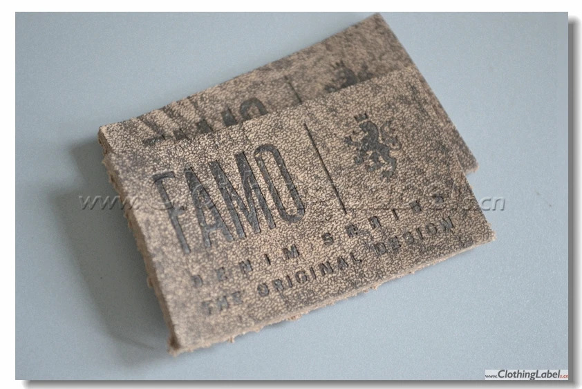 

custom genuine leather label with special surface and embossed logo, die cut