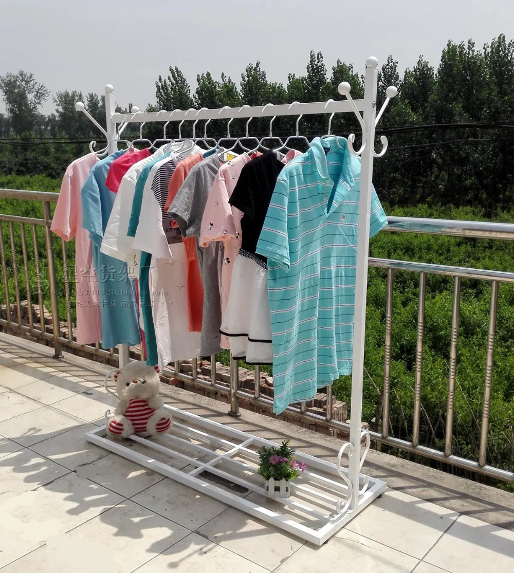 

European indoor room, wrought iron hang clothes tree. Hangers. Clothes rack