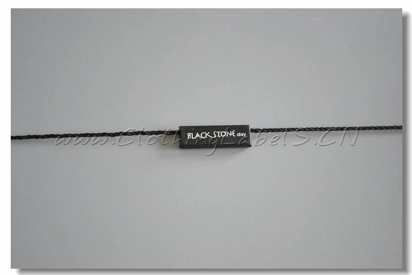 

Hang tag string, plastic seal, black swing tag seal with white logo printing as custom design