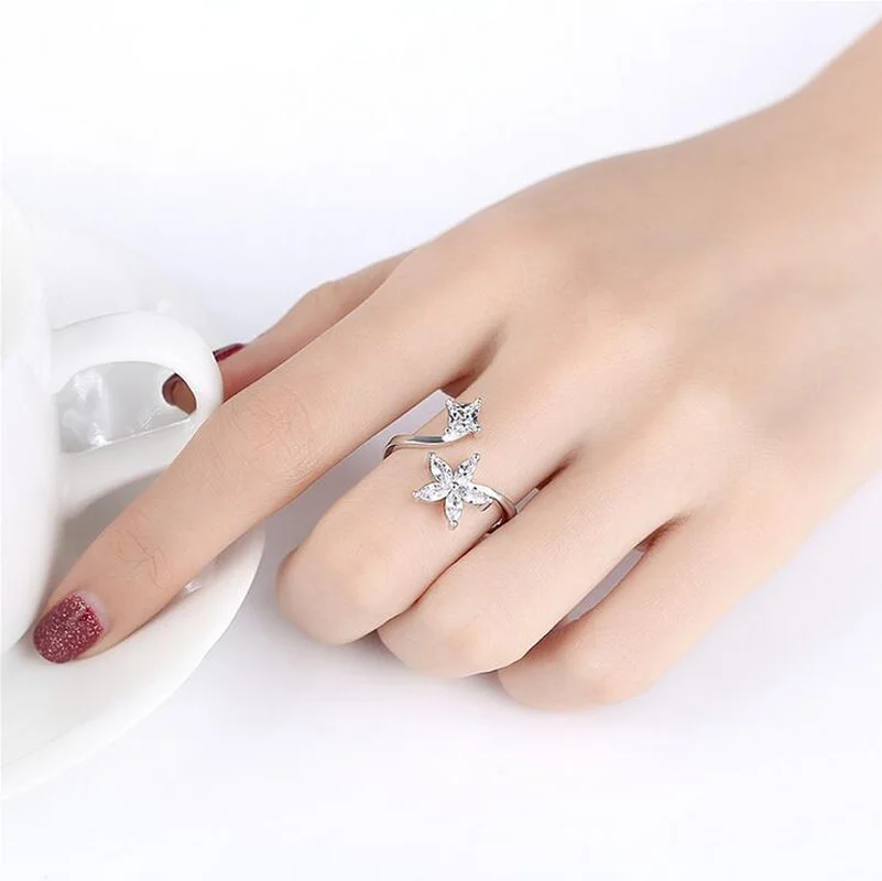 Женское кольцо с цветком и звездой простое Открытое из серебра 925 пробы белым