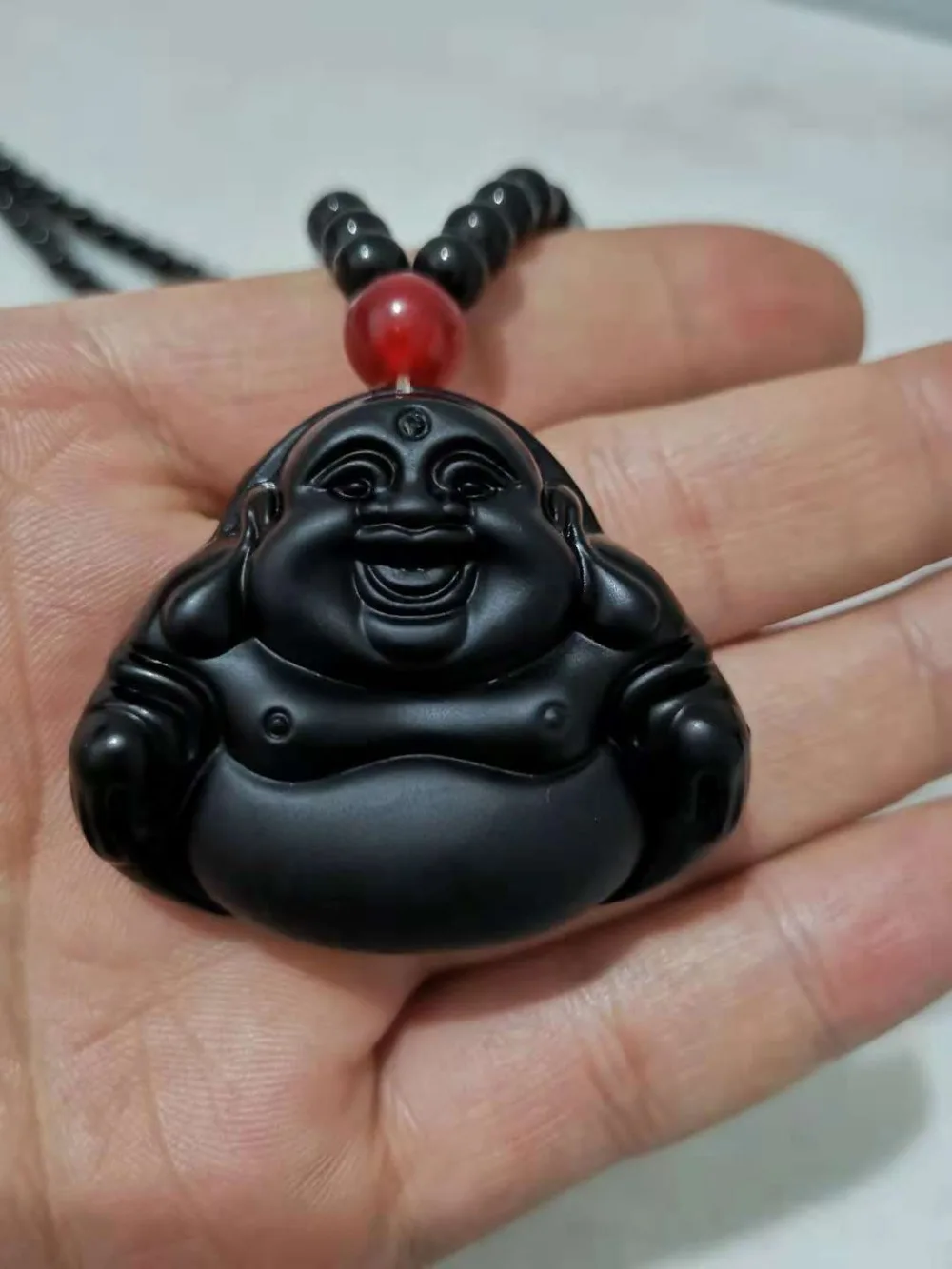 

The natural Obsidian Maitreya pendant is always laughing and laughing.