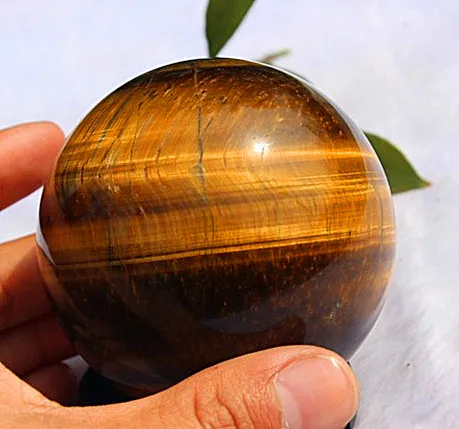 

Natural tiger eye crystal crystal ball. Reiki gem and mineral feng shui furnishings for home decoration