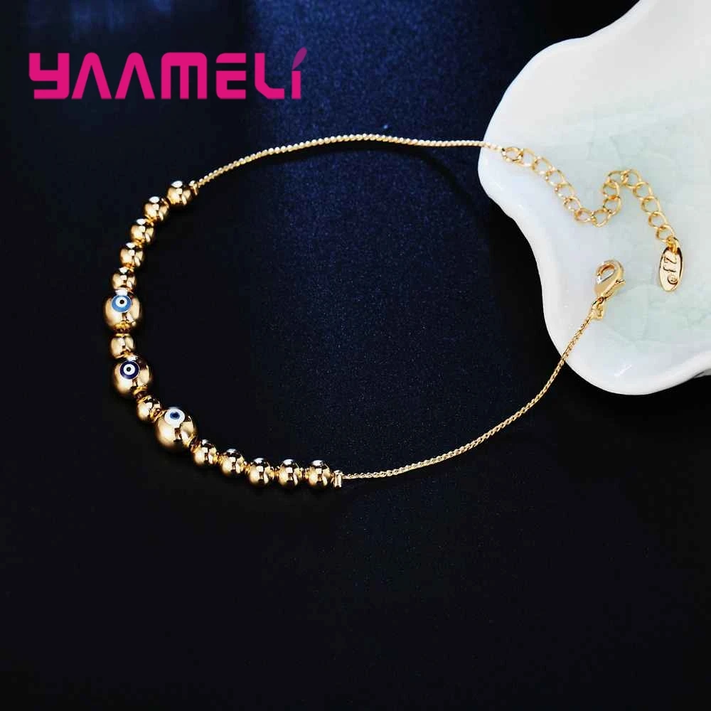 Женский браслет с бусинами золотистый/серебристый голубой от сглаза | Украшения