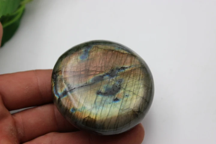 

133 grams of a quartz crystal labradorite press of the hand