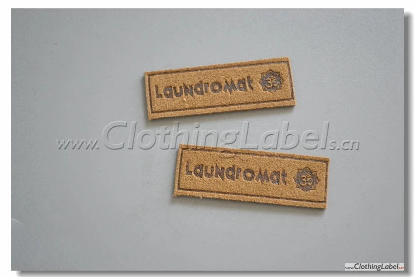 

custom suede leather label with embossed logo, brown color, microfibre fabric