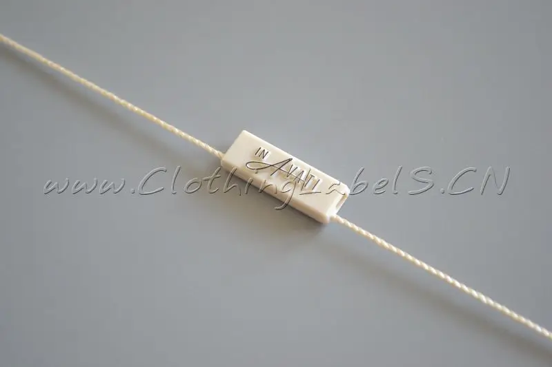 

Custom hang tag string, plastic seal for clothing, white background with grey embossed logo, total length 27cm.
