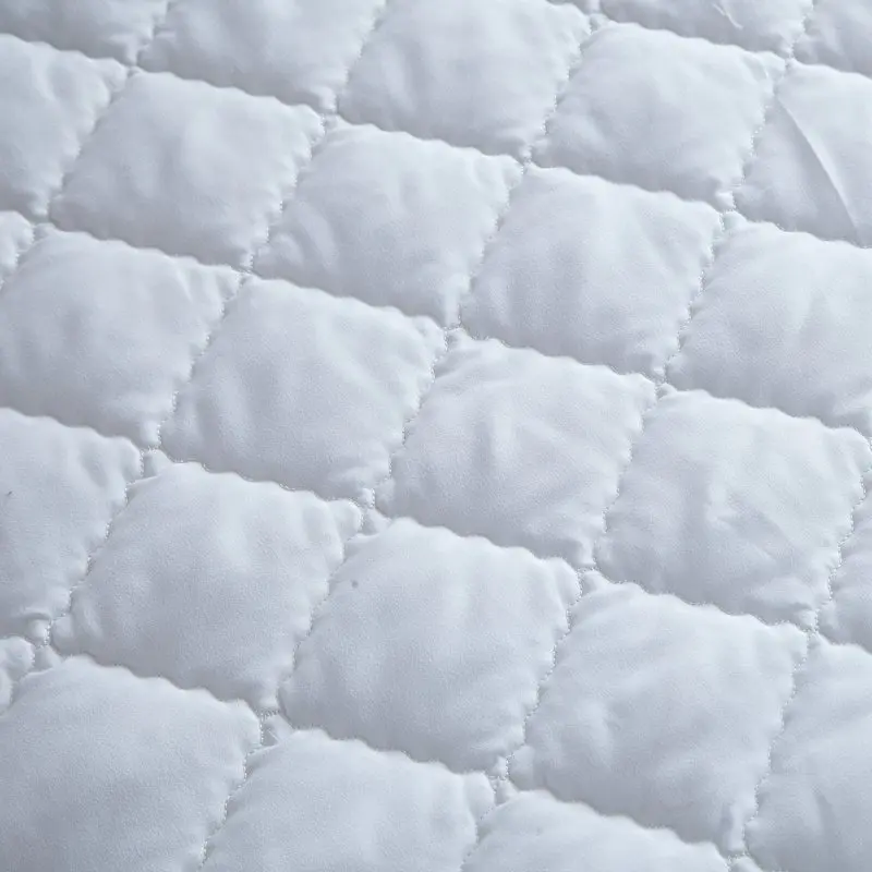 Стеганый матрас протектор белого цвета для защиты кровати из полиэстера