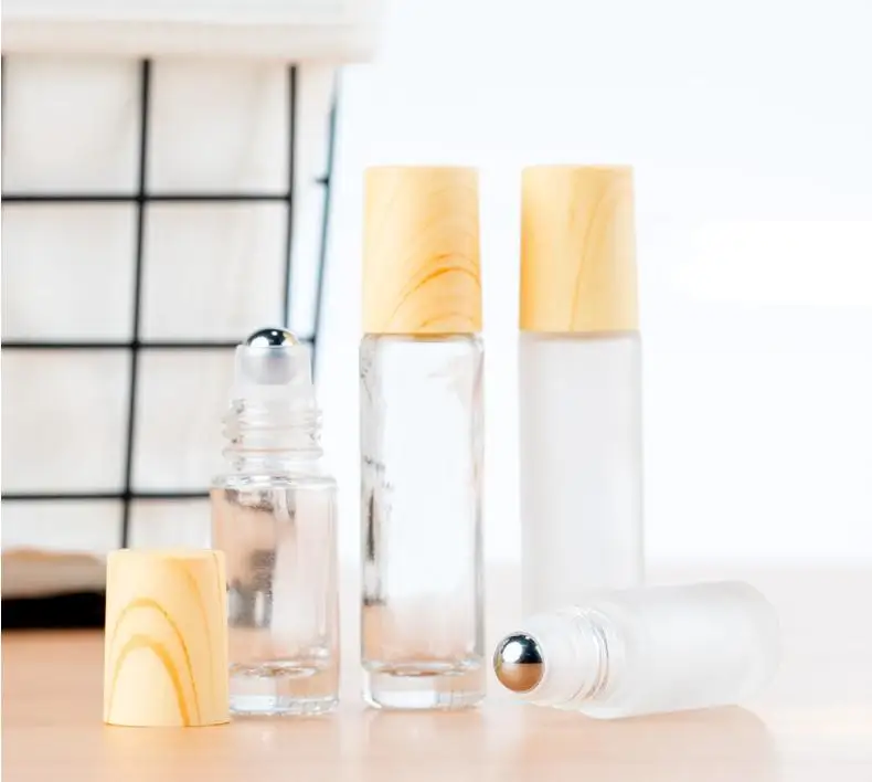 

Frosted Clear Glass Roller Bottles Containers with Metal Roller Ball and Wood Grain Plastic Cap for Essential Oil Perfume SN1630