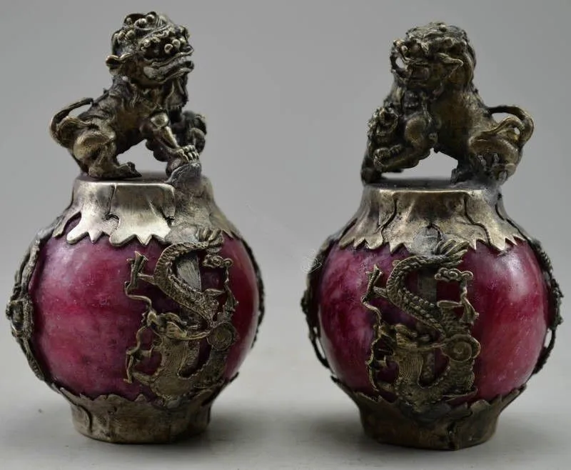 

A Pair of Elaborate Chinese Classical feng shui miao silver lion dragon phoenix inlaid with artificial red jade statues.