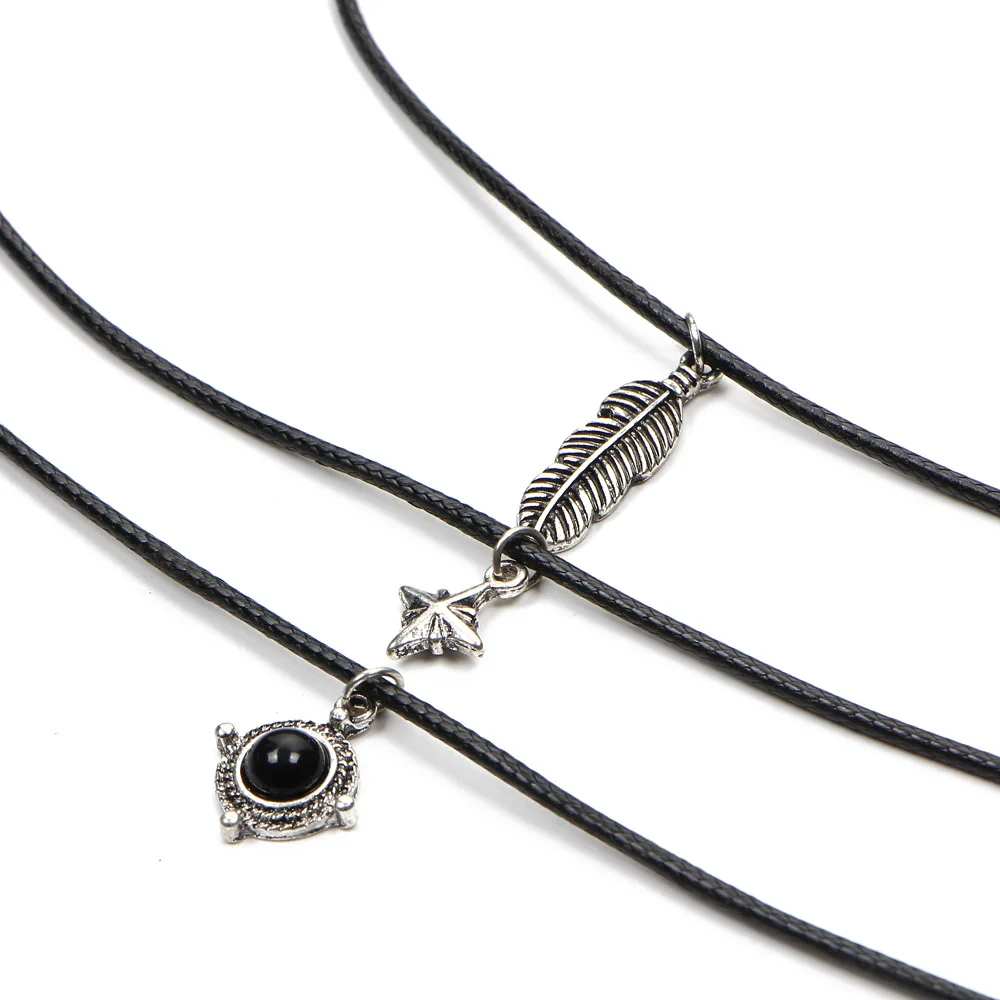 Бархатные ожерелья с перьями листьями звездами кулонами из черного камня