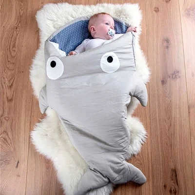 Baby shark sleeping bag autumn and winter newborn baby anti-kick is being held by cotton padded stroller |