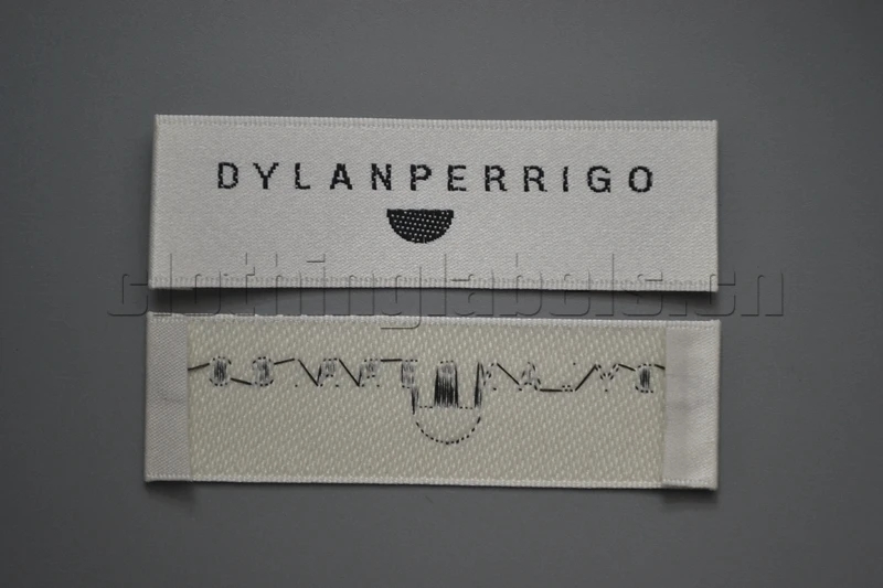 

custom selvage woven clothing label, beige background with black logo