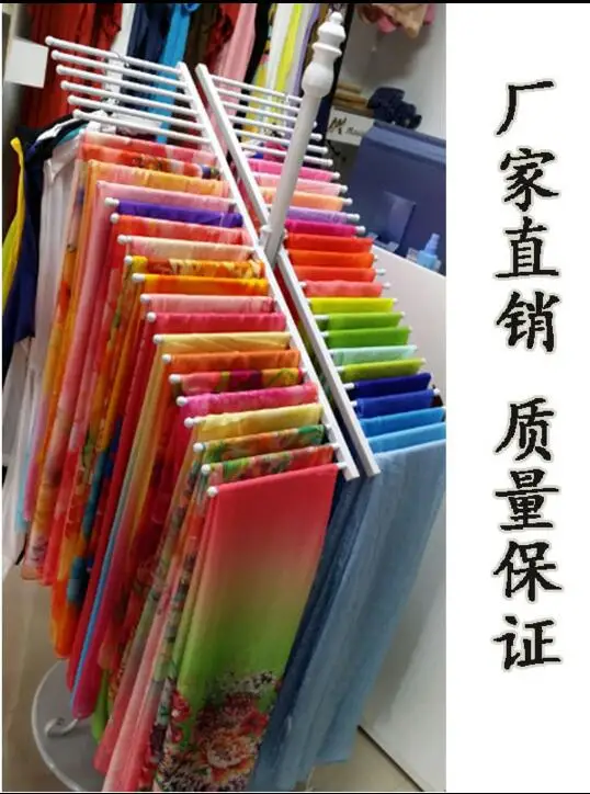 

The clothes shop floor hangs a silk scarf to display the rack