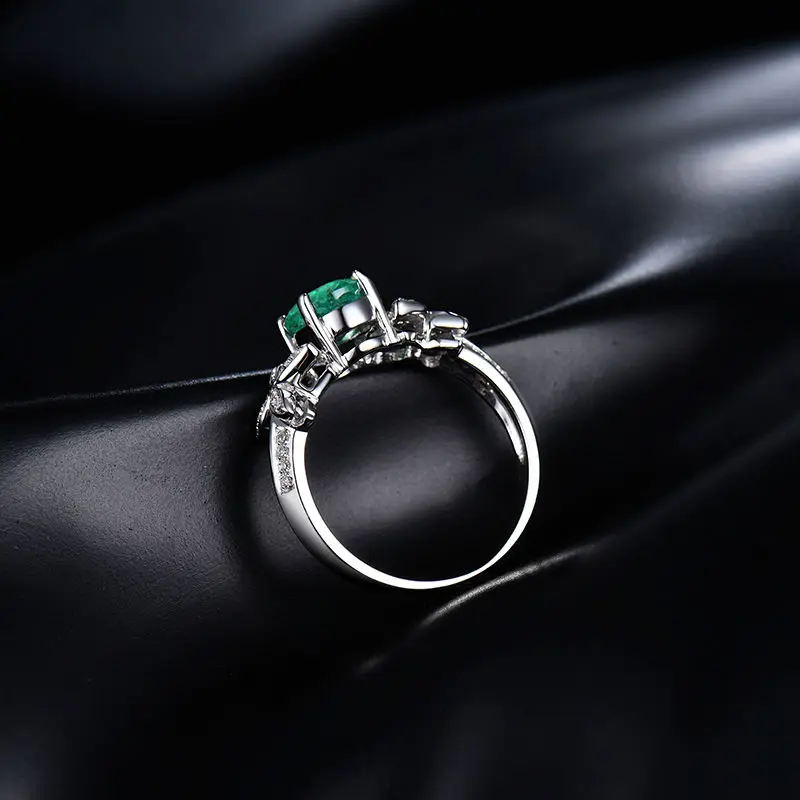 Женское кольцо с овальным камнем 5 х7 мм из твердого белого золота 14 карат зеленым