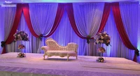 white wedding backdrop with red swags luxury wedding decoration
