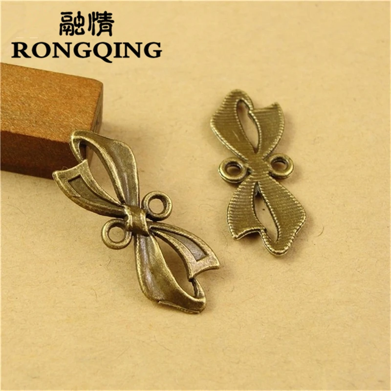 

RONGQING 50pcs/lot 11*28MM Bow tie alloy Bronze Charms handmade Craft pendant making fit DIY for bracelet necklace