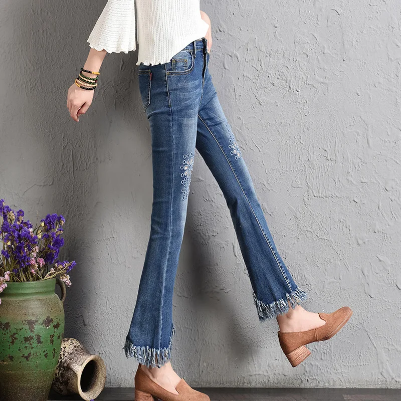 

Autumn winter new fashion Korean version 100 waist high waist embroidered bell trousers broken hole tassel denim trousers female