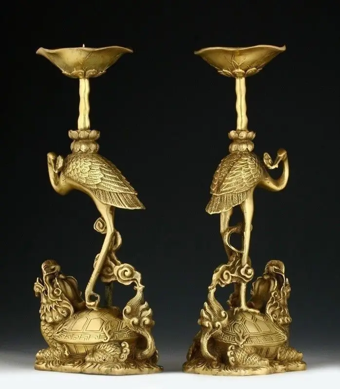

A PAIR OF ORIENTAL CHINESE CARVED COPPER CANDLE STICK-CRANE STATUES