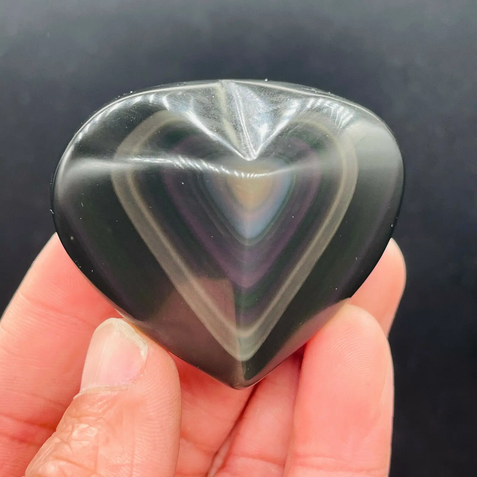 

A carved heart of natural obsidian carves a colored lamp