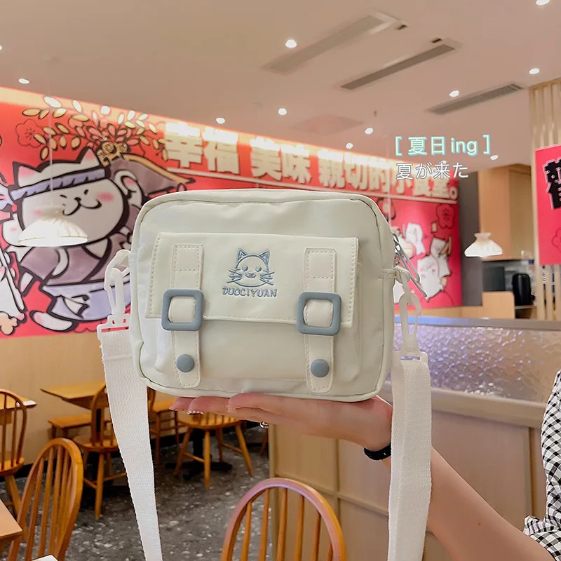

Japanese Harajuku bag female 2021 new Korean fashion simple student small square bag contrast color small fresh messenger bag.