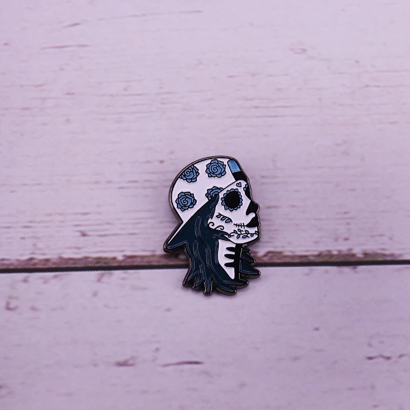 Sugar skull skater enamel pin backwards hat with a blue floral pattern brooch